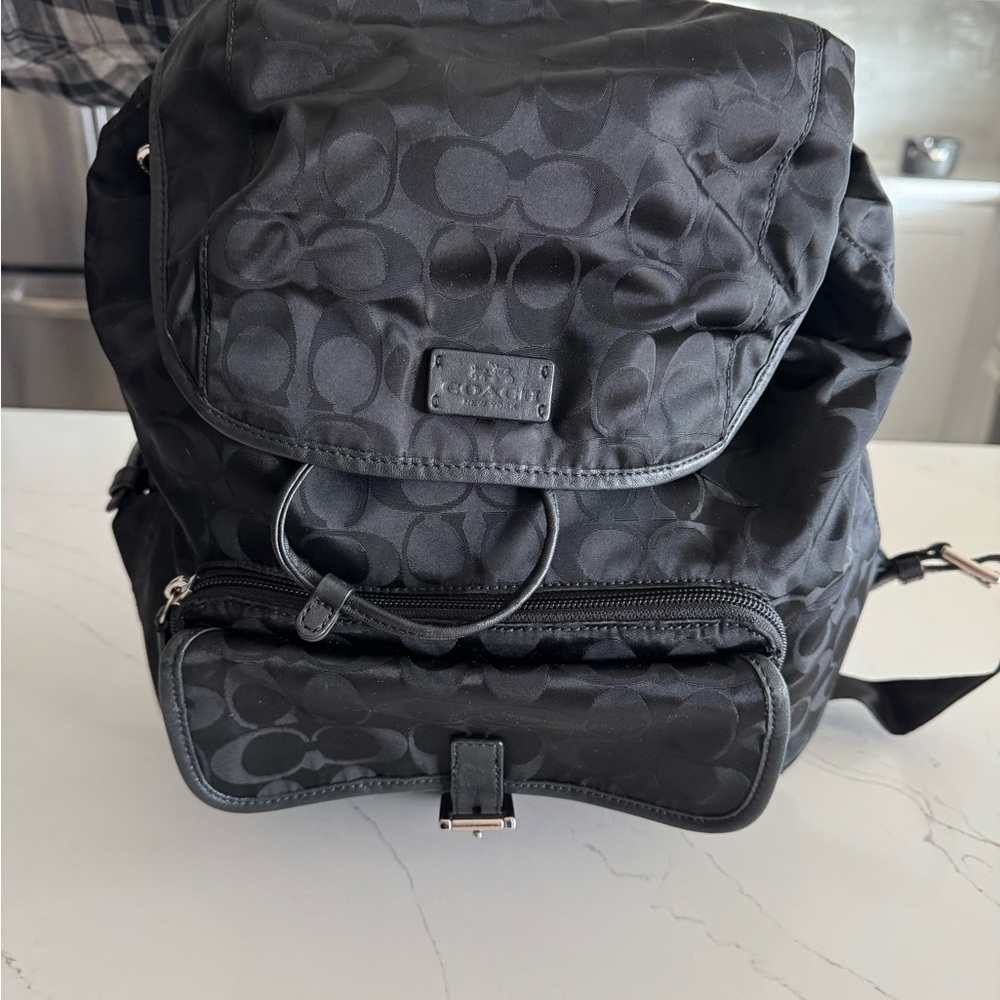Coach Black Backpack with Monogram Design and Flap Closure